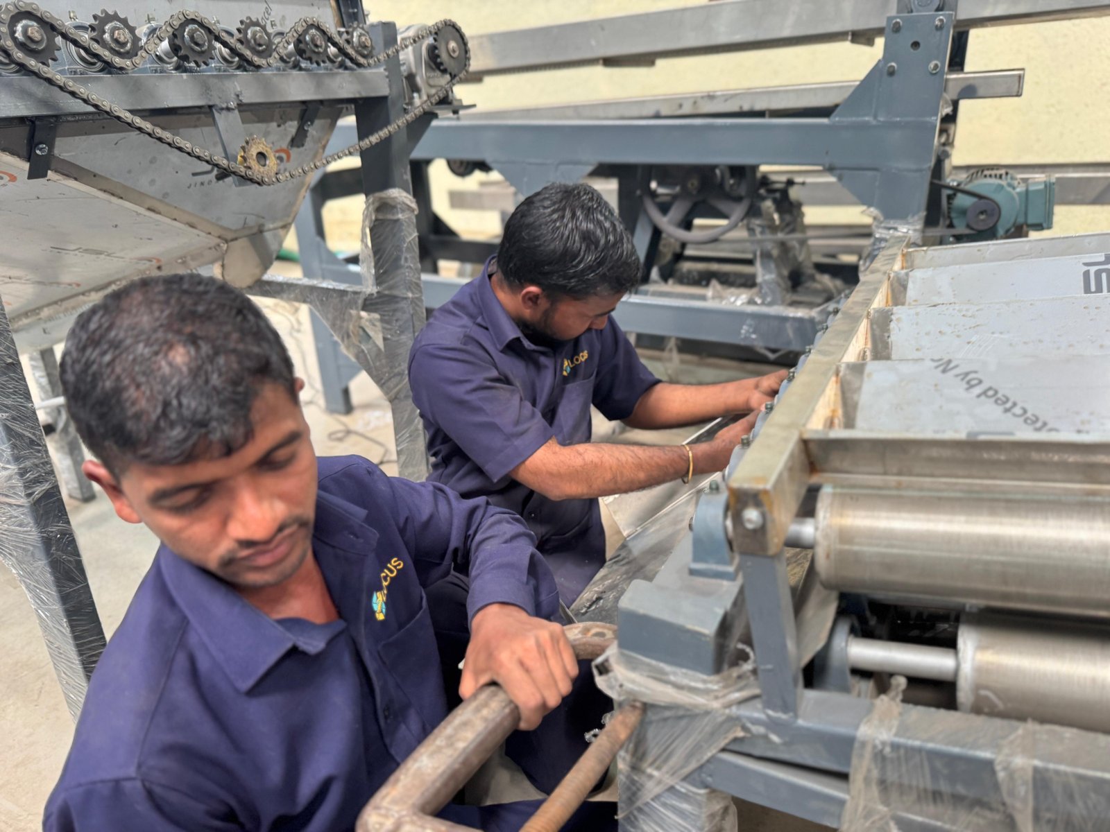 LOCUS technicians assembling a cashew processing machine